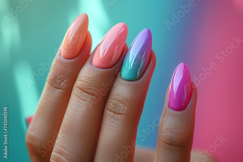 A close up of a womans hand showcasing colorful nail polish in shades of pink and azure  emphasizing nail care and manicure gesture with liquid nail polish