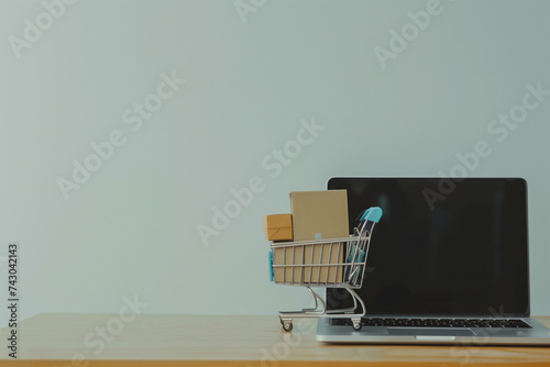 Online shopping and delivery concept, product package boxes in cart and laptop computer