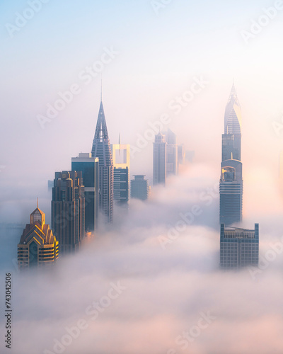 Aerial view of downtown Dubai with fog and mist, Shangri La Dubai and Sheik Zayed Road, United Arab Emirates. photo