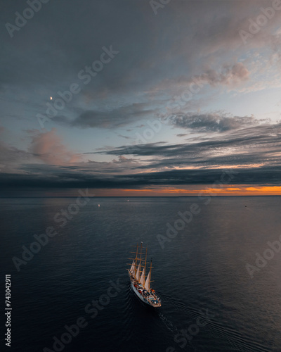 Aerial view of tranquil bay with luxury yachts sailing in the sunset, Primorje-Gorski Kotar, Croatia.