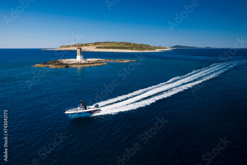 Croatia - 9 May 2019: Aerial view of a beautiful blue bay with boats sailing in the high sea, Primorje-Gorski Kotar, Croatia. photo