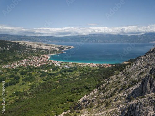 Aerial view of clear turquoise water and green coastline in Baska Island, Croatia. photo