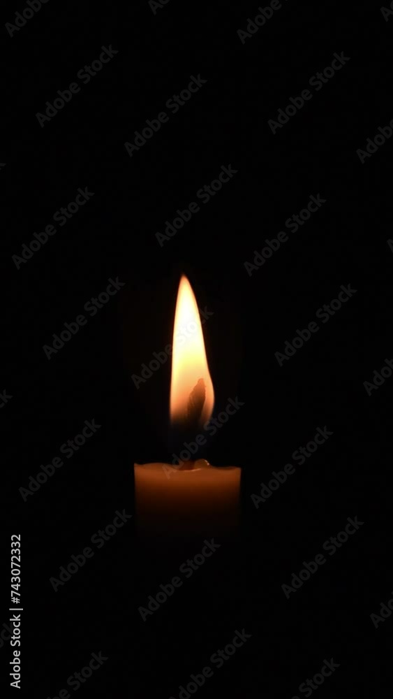 Close up single candle blown in the dark