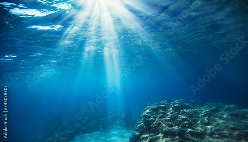 Underwater background with blue water and sun rays. Copy space  © Marko