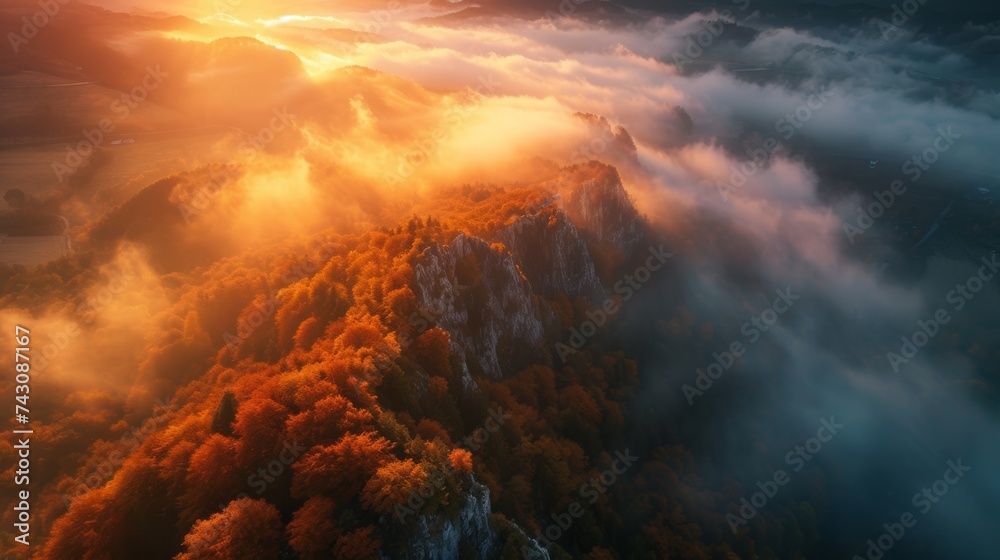 Aerial View of a Lush Mountain Peak Piercing Through Mist at Sunset in Slovenia