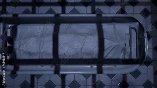 Two doctors standing in fron of a corpse in the morgue and ready to execute an autopsy