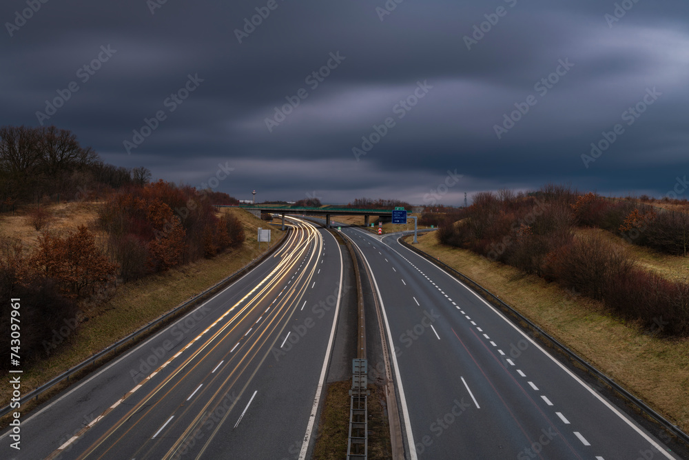 Highway near Krusne mountains with night lines from cars