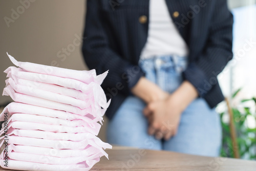 woman have an allergic reaction to Menstrual Pads feel vaginal itching, swelling, and redness caused by rashes with sanitary pads on a table