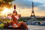 Bottle and wineglasses with ripe grapes on table on Eiffel Tower background