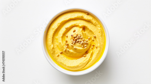 Bowl of hummus with greens and olive oil, top view, copy space