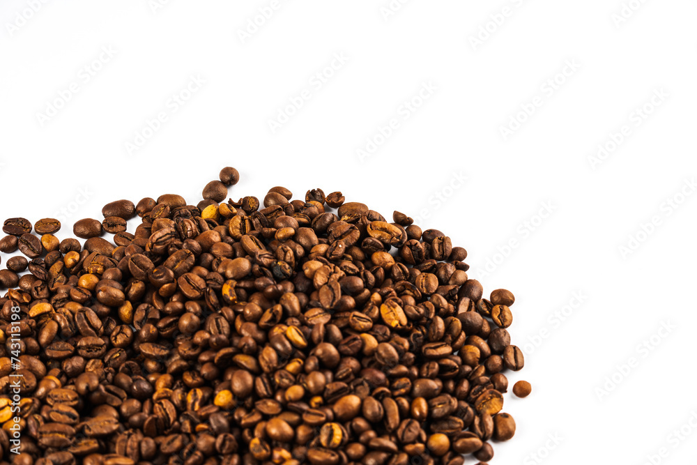 Coffee beans on a white background. A heap of coffee beans on white. Morning coffee Coffee beans on a white background. A heap of coffee beans on white. Morning coffee