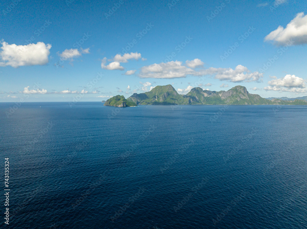 Helicopter Island and Cadlao Island with blue sea. Blue sky and clouds. El Nido, Philippines. Helicopter Island and Cadlao Island with blue sea. Blue sky and clouds. El Nido, Philippines.