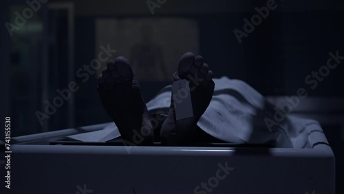 Two doctors standing in fron of a corpse in the morgue and ready to execute an autopsy