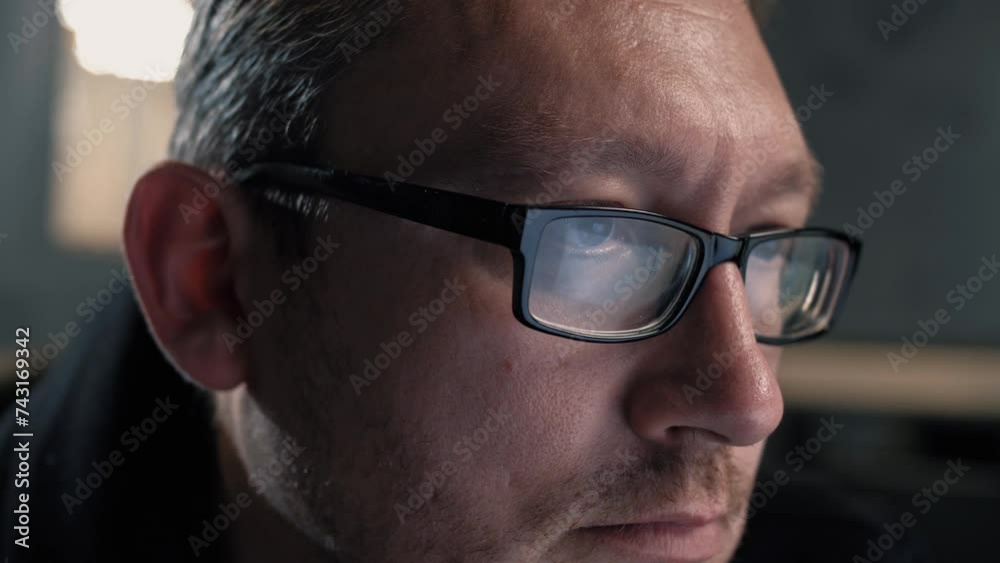 Mature male manager in glasses working behind a computer screen. Portrait. Close-up Mature male manager in glasses working behind a computer screen. Portrait. Close-up