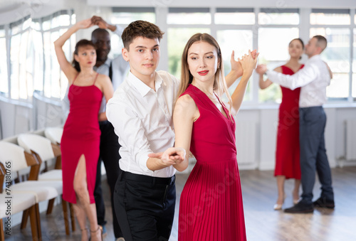 During rehearsal of reporting concert, young man and girl participants of dance workshop perform figure waltz. Group training and rehearsal, preparation for competitions