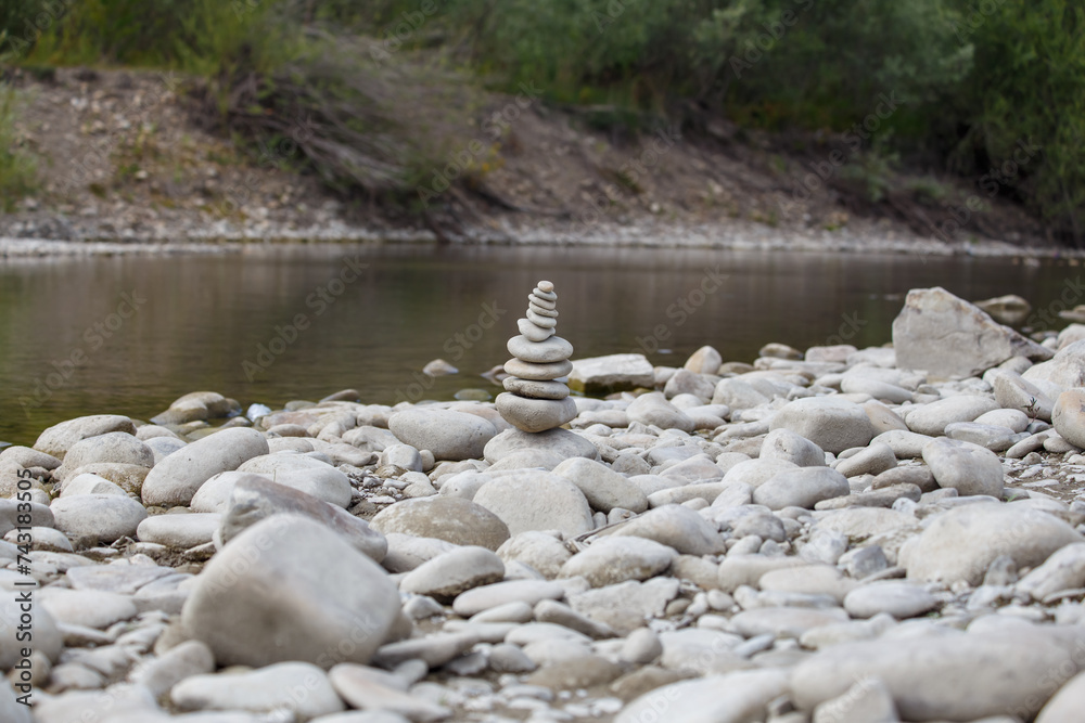 Amazing round stone near a flowing river, Stones are perfectly balanced on one another and forming, These are river stones, or also buddha stones