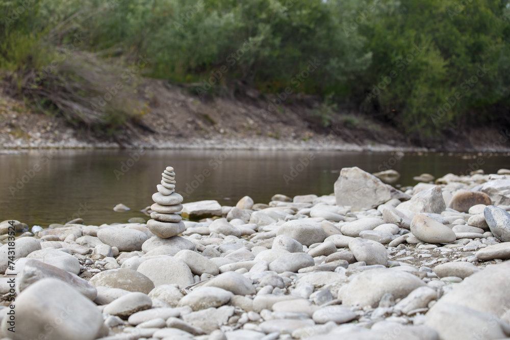 Amazing round stone near a flowing river, Stones are perfectly balanced on one another and forming, These are river stones, or also buddha stones