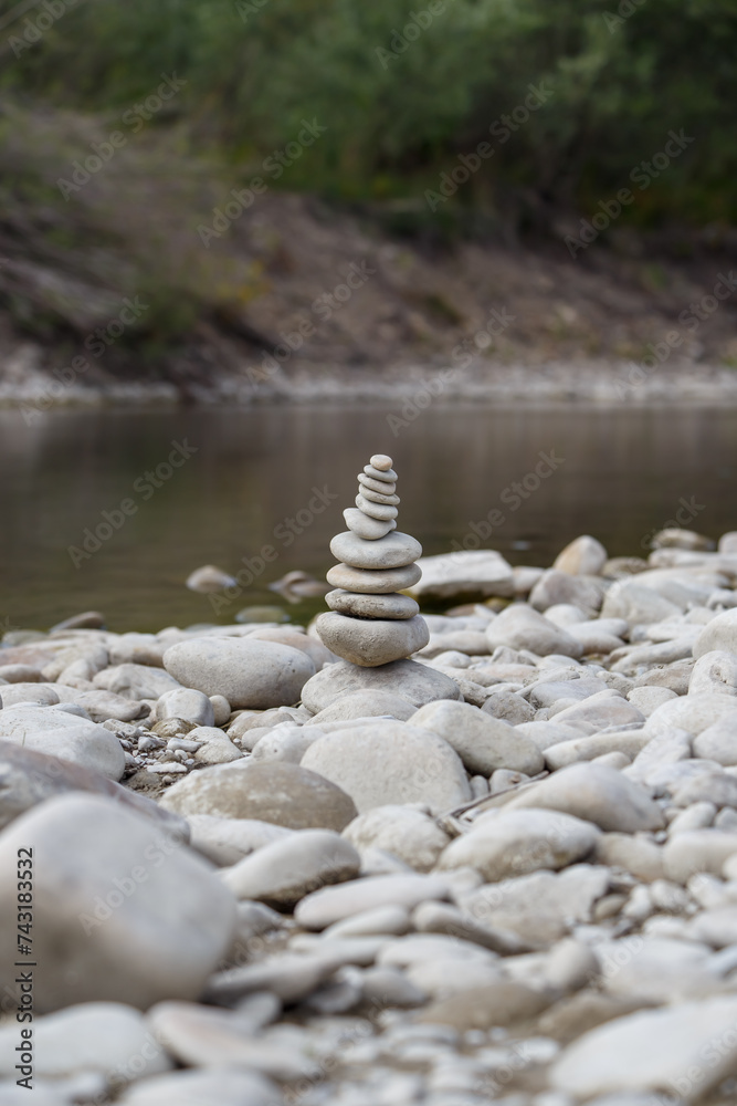 Amazing round stone near a flowing river, Stones are perfectly balanced on one another and forming, These are river stones, or also buddha stones