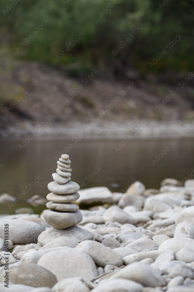 Amazing round stone near a flowing river, Stones are perfectly balanced on one another and forming, These are river stones, or also buddha stones