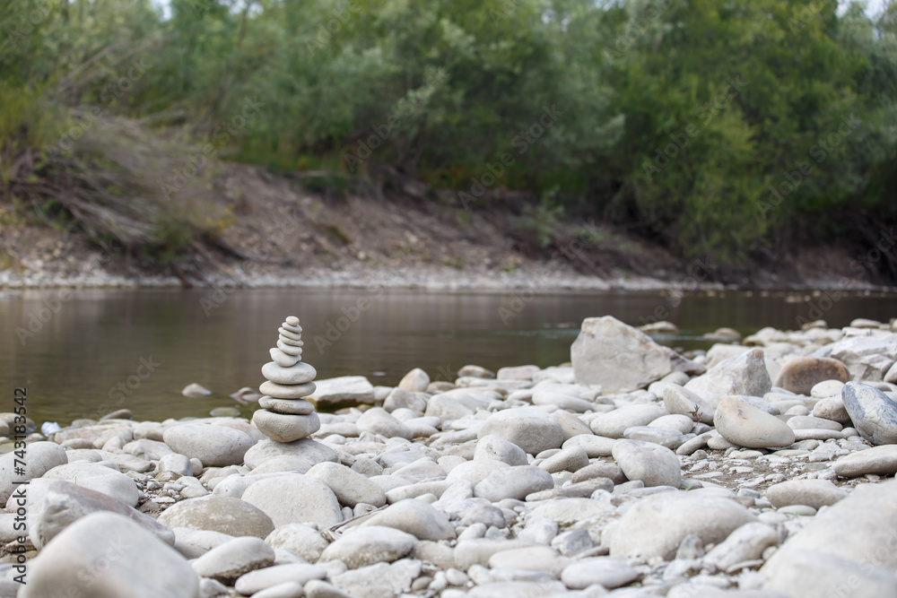 Amazing round stone near a flowing river, Stones are perfectly balanced on one another and forming, These are river stones, or also buddha stones