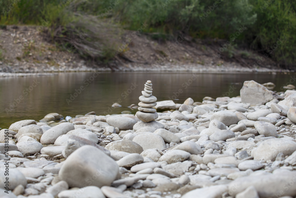 Amazing round stone near a flowing river, Stones are perfectly balanced on one another and forming, These are river stones, or also buddha stones