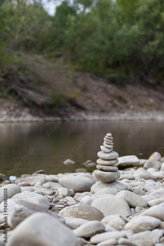 Amazing round stone near a flowing river, Stones are perfectly balanced on one another and forming, These are river stones, or also buddha stones