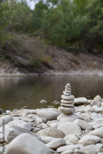 Obraz na płótnie Amazing round stone near a flowing river, Stones are perfectly balanced on one another and forming, These are river stones, or also buddha stones w salonie