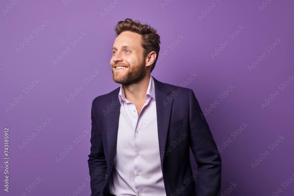 Portrait of a handsome young man in a suit on a purple background. Portrait of a handsome young man in a suit on a purple background.
