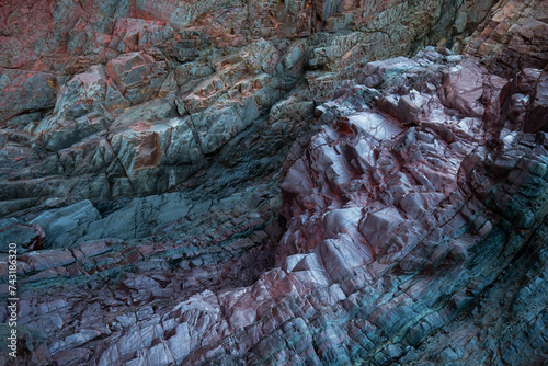 Textured rocks with biofilm at Llumeres old mine beach photo