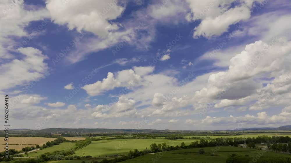 Drone forward motion over verdant fields under blue sky Drone forward motion over verdant fields under blue sky