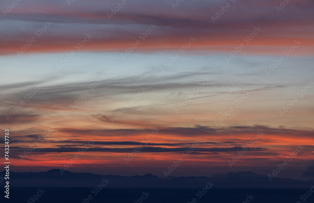 Red sky on the mountain range silhouette