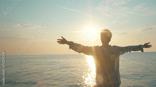 Young man arms outstretched by the sea at sunrise enjoying freedom and life people travel wellbeing concept : Generative AI