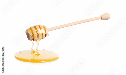 Natural honey dripping from dipper on white background