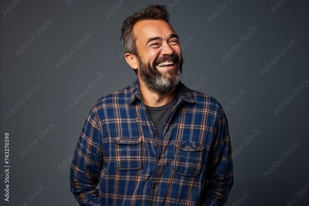 Portrait of a middle-aged man laughing over grey background. Portrait of a middle-aged man laughing over grey background.