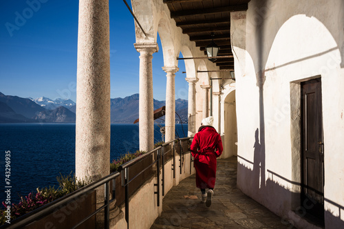 Asian woman visiting a monastery on Lake Maggiore, Santa Caterina del Sasso, Lombardy, Italy photo