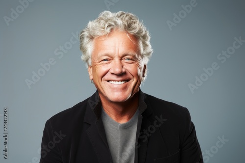 Portrait of a happy senior man. Isolated over grey background. © Chacmool