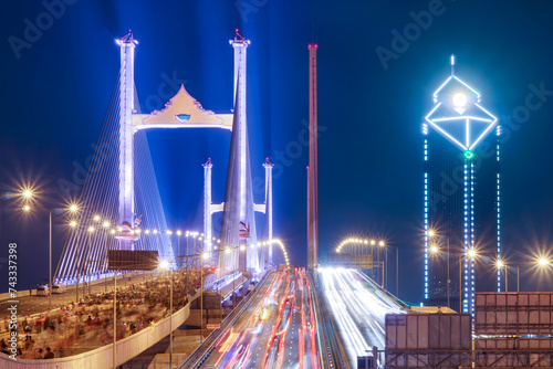 The Rama IX parallel bridge is adorned with colorful lights that create a stunning visual spectacle. It is considered to be Thailand s first double cable-stayed bridge across the Chao Phraya River.