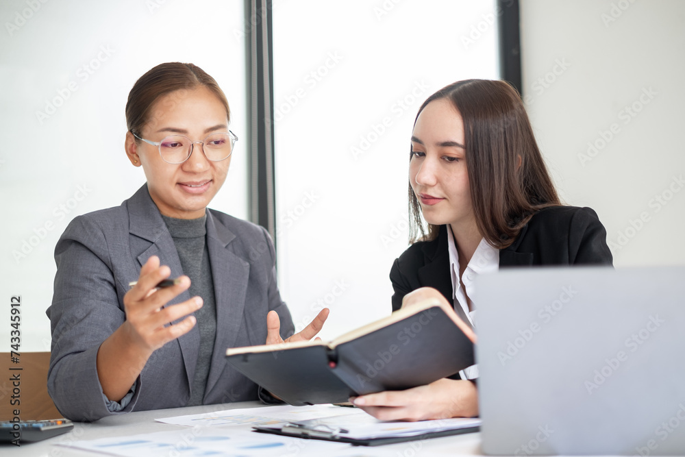 Business leaders talk about charts and finance graphs showing results are analyzing and calculating planning strategies, business success-building processes Business leaders talk about charts and finance graphs showing results are analyzing and calculating planning strategies, business success-building processes
