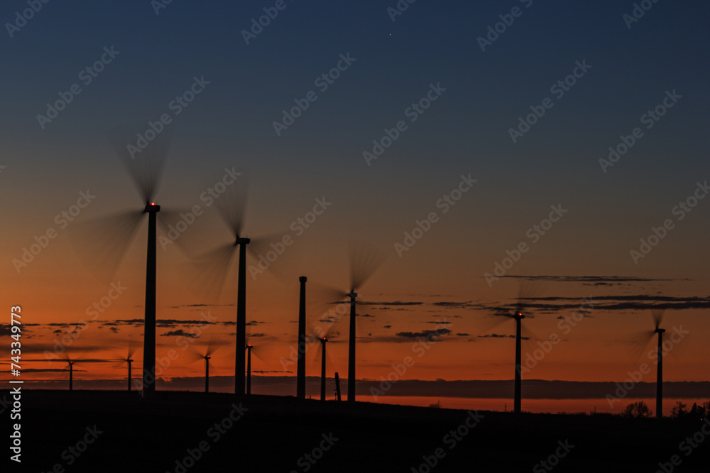 long exposure of wind turbines at sunset