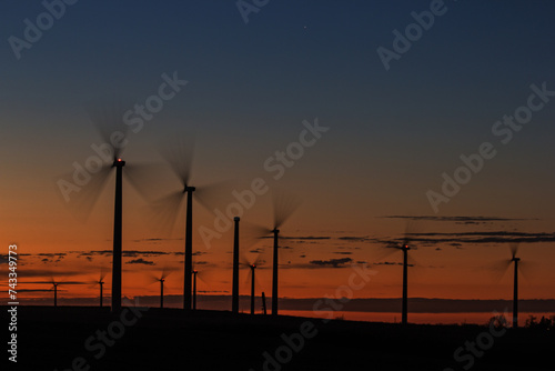 long exposure of wind turbines at sunset © Peter