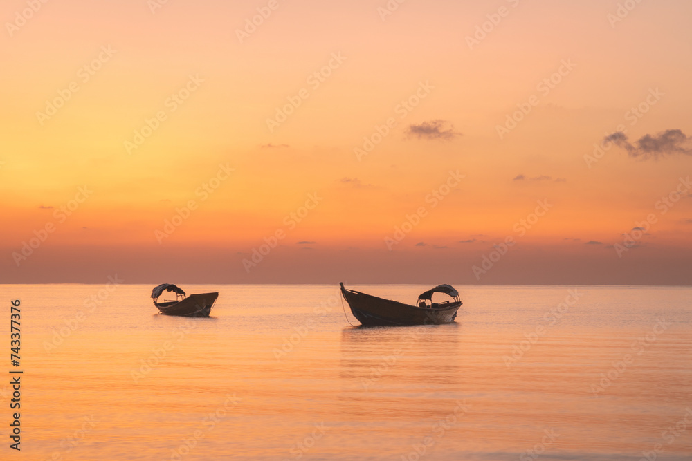 Traditional fishermen boat at the coast of Havelock island in Andaman islands archipelago during colorful sunset