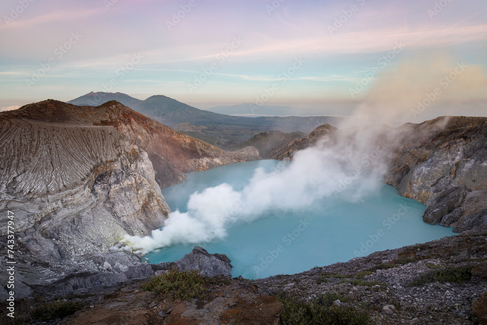 Famous Ijen volcano crater and acidic lake panoramic view during colorful sunrise in East Java