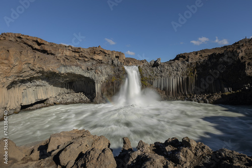 Scenic Aldeyjarfoss waterfall and basalt columns in the north of Iceland on a bright sunny day