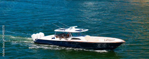 Boat trip. Travel and adventure. Motor private yacht in sea. Yacht in navigation. Private boat off the beach. Summer vacation. Summertime yachting. Yacht vacation in summer. Motorboat rental