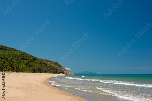 Sink your toes into the golden sands of Wangetti Beach  Far North Queensland  where crystal-clear waters meet pristine coastline.