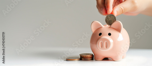 Closeup male hands putting coin into piggy bank, The concept of saving money, finance, stack coins, investment, fund