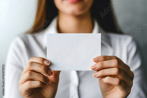 Caucasian woman Hand holding blank business card on white background