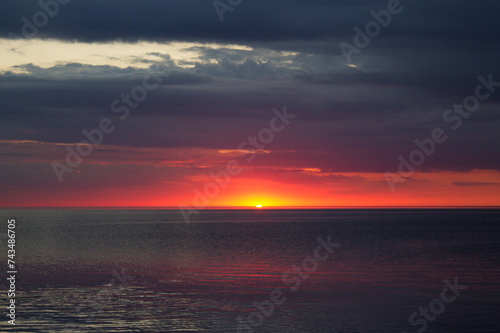 Colorful sunset over Lake Peipsi. Pskov region, Russia.