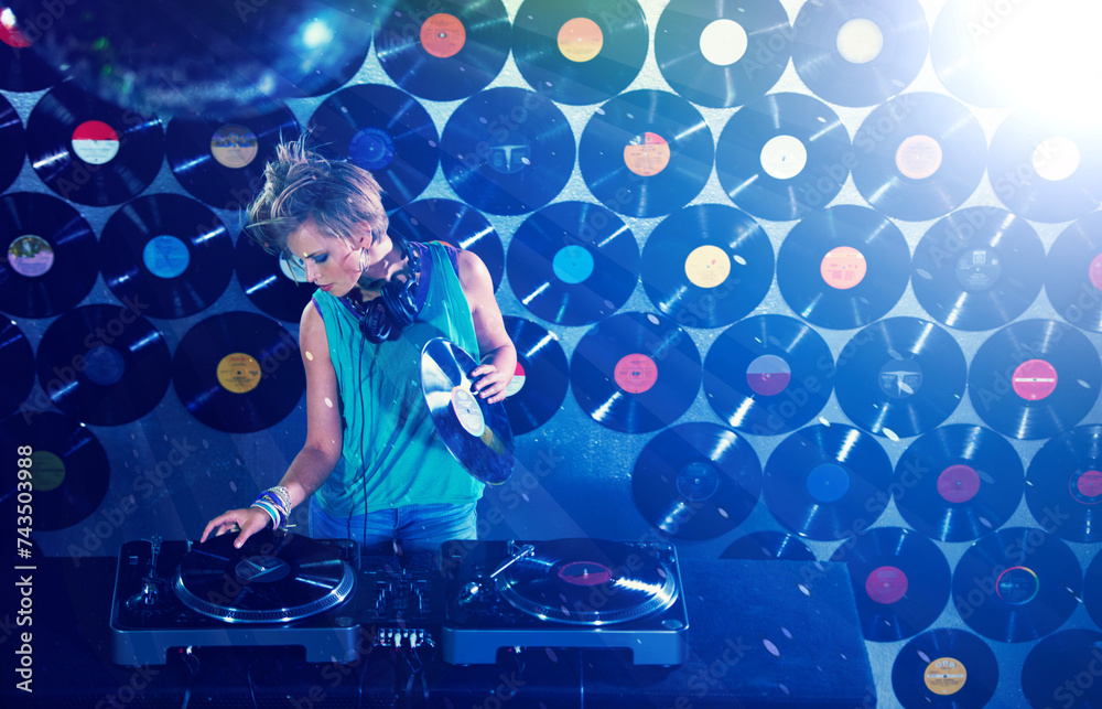 Naklejka premium Woman dj, headphones and vinyl records in night club for party with turntable, lights and lens flare. Gen z female person, retro or mixing decks at event with energy, techno and music in Berlin disco