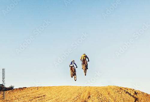 Fotografie Rear view, racer and motorcycle in action for competition on dirt road with performance, challenge and adventure